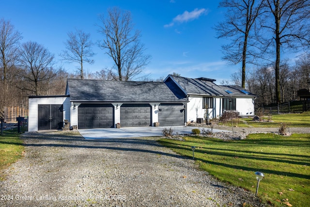 view of front of house with a front yard and a garage