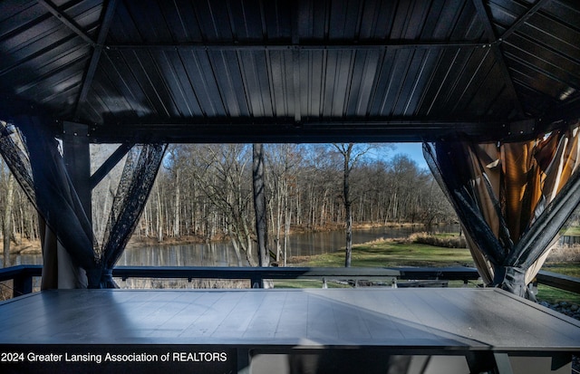 exterior space with a water view and lofted ceiling