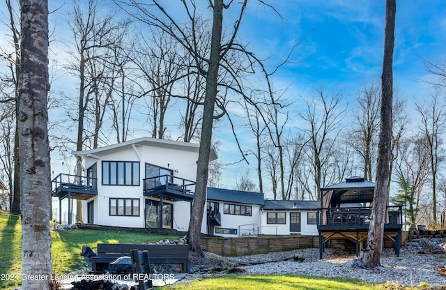 back of property with a gazebo and a yard