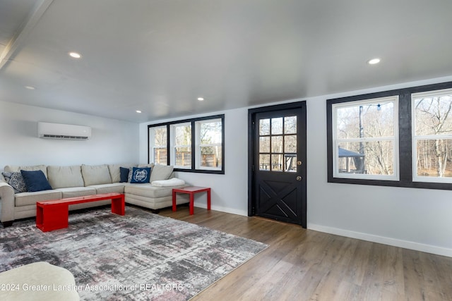 living room with hardwood / wood-style floors and a wall mounted AC