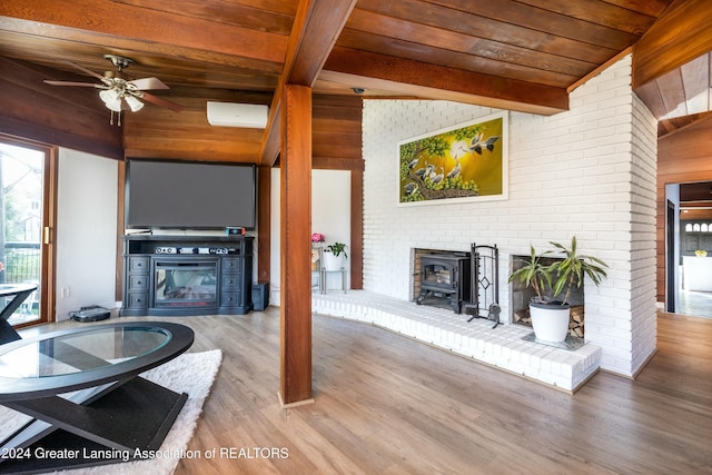 living room with ceiling fan, lofted ceiling with beams, wood-type flooring, a fireplace, and wood ceiling