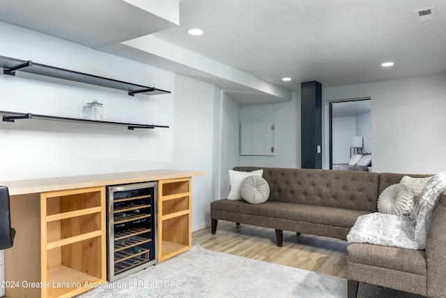 bar with wine cooler and hardwood / wood-style floors