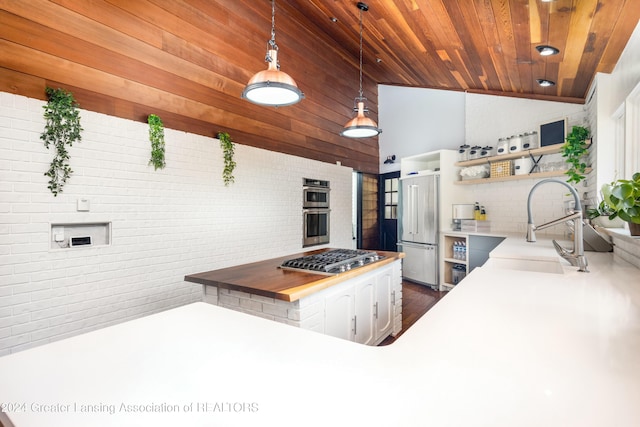 kitchen with kitchen peninsula, wood ceiling, stainless steel appliances, hanging light fixtures, and butcher block counters