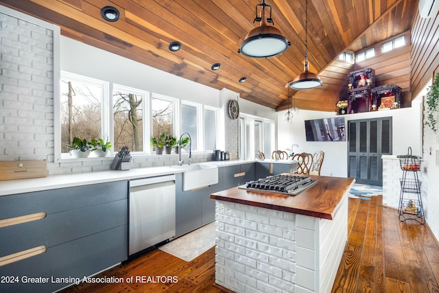 kitchen with wood counters, wooden ceiling, vaulted ceiling, decorative light fixtures, and stainless steel appliances