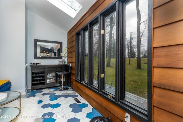 interior space with vaulted ceiling with skylight