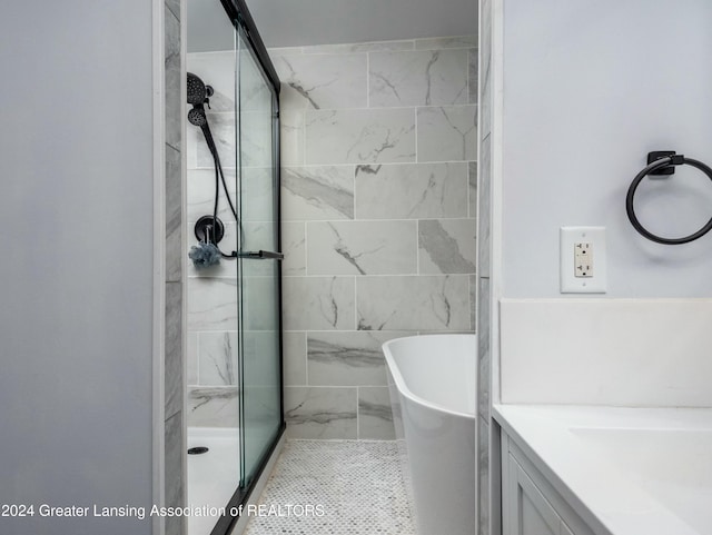 bathroom featuring vanity and separate shower and tub