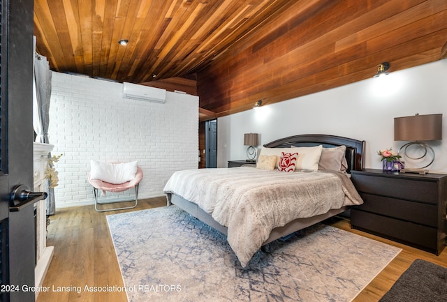 bedroom featuring a wall mounted air conditioner, light hardwood / wood-style floors, wood ceiling, and brick wall