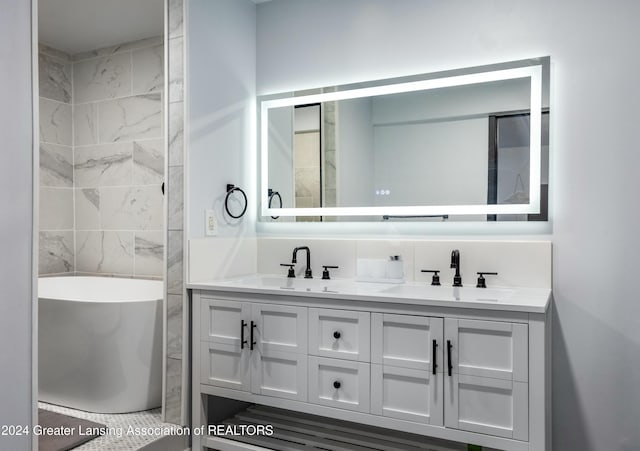 bathroom featuring vanity and a bath