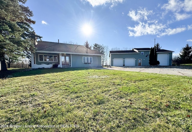 single story home featuring a front lawn and a garage