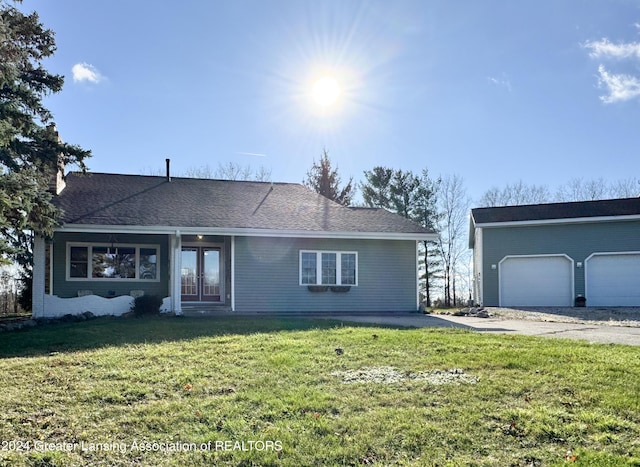 ranch-style house with a garage and a front lawn