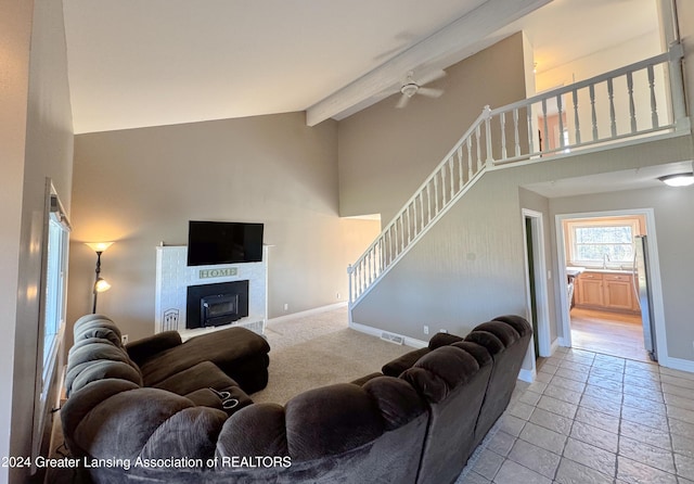 living room featuring beamed ceiling, sink, and high vaulted ceiling