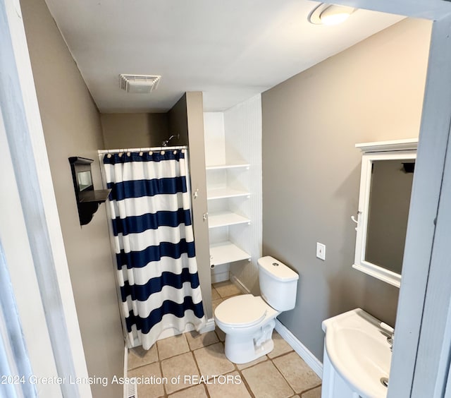 bathroom featuring tile patterned flooring, toilet, sink, and a shower with shower curtain