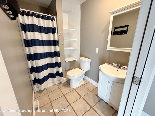 bathroom featuring tile patterned flooring, a shower with curtain, toilet, and sink