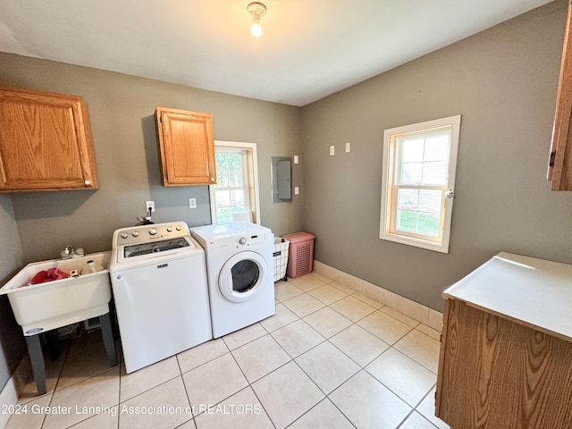 washroom featuring sink, cabinets, separate washer and dryer, electric panel, and light tile patterned floors