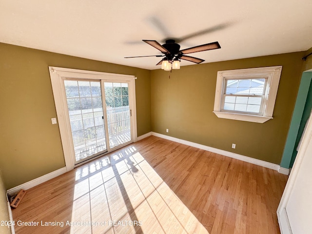 unfurnished room with ceiling fan and light wood-type flooring