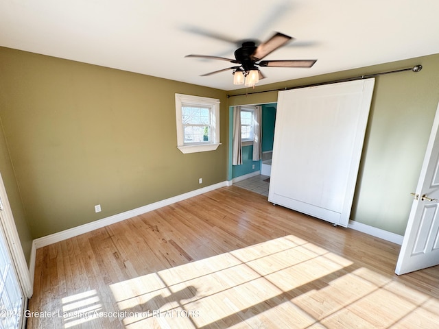 unfurnished bedroom featuring ceiling fan and light wood-type flooring