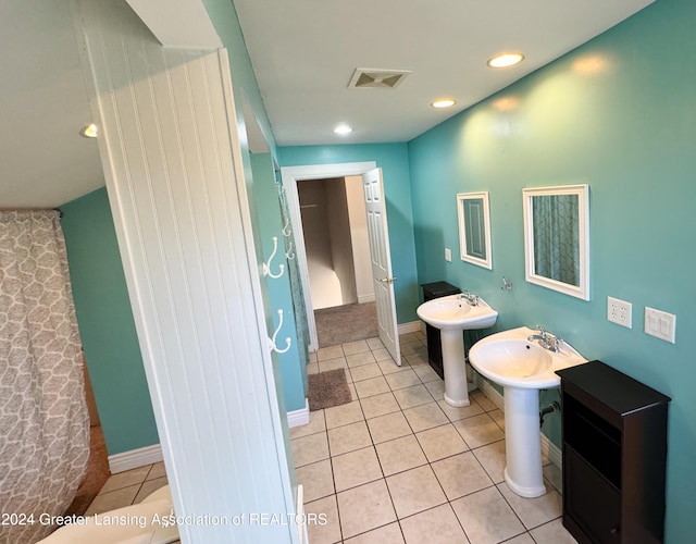 bathroom featuring tile patterned floors and dual sinks