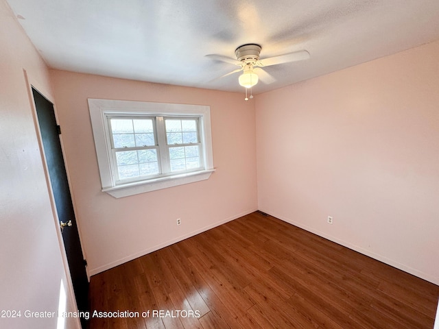 unfurnished room with ceiling fan and dark hardwood / wood-style floors