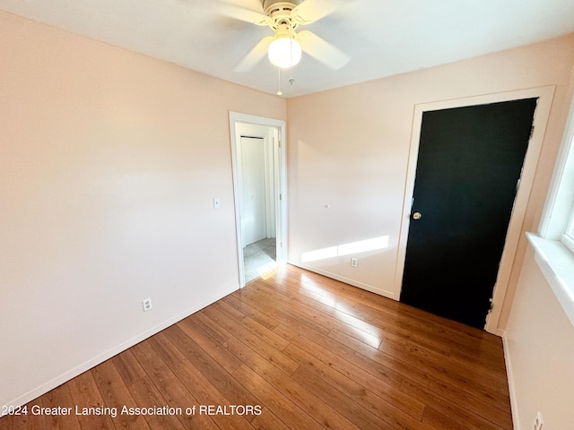 unfurnished room with ceiling fan and hardwood / wood-style flooring