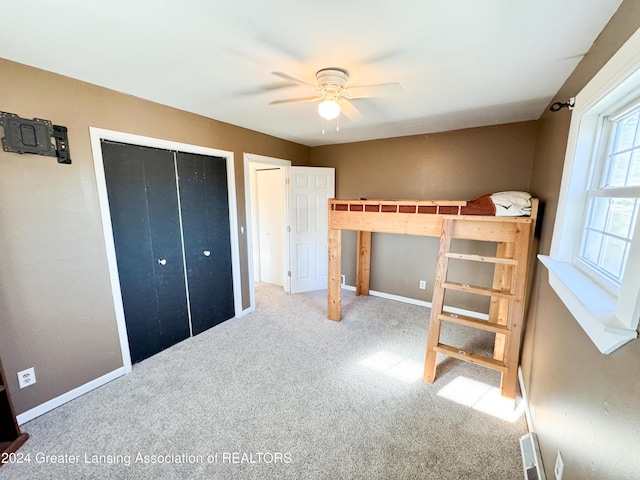 unfurnished bedroom with carpet flooring and ceiling fan