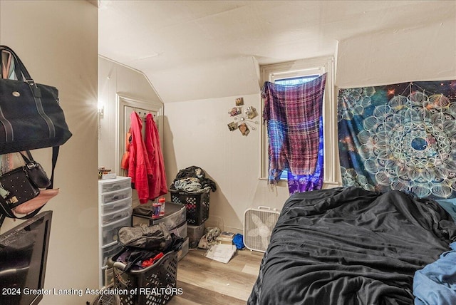 bedroom featuring hardwood / wood-style flooring and vaulted ceiling