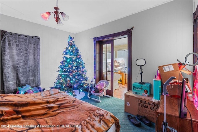 bedroom featuring a notable chandelier