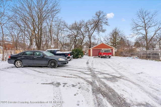 snowy yard with an outdoor structure and a garage