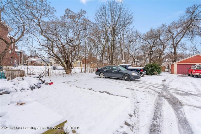 yard covered in snow with a garage