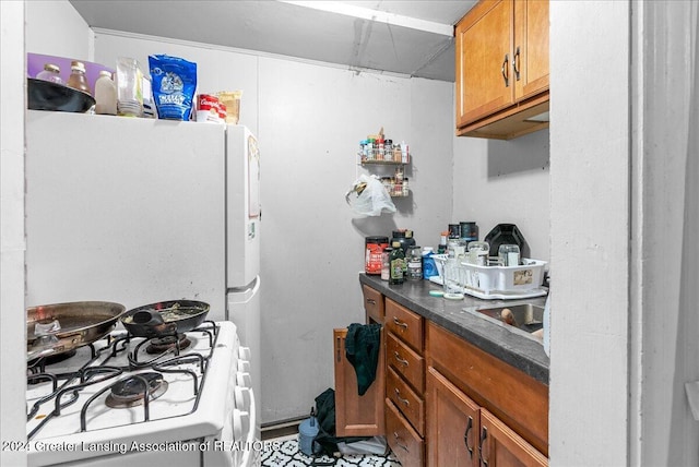 kitchen featuring white appliances and sink