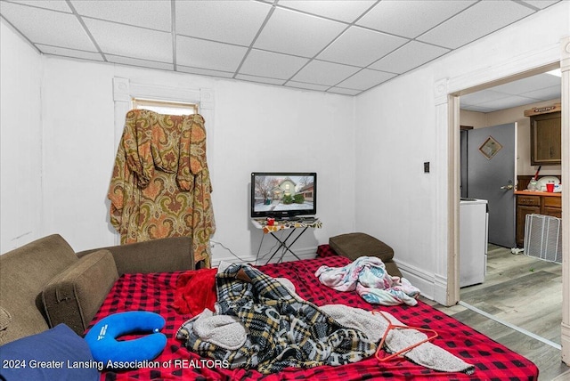 bedroom featuring a paneled ceiling and hardwood / wood-style flooring