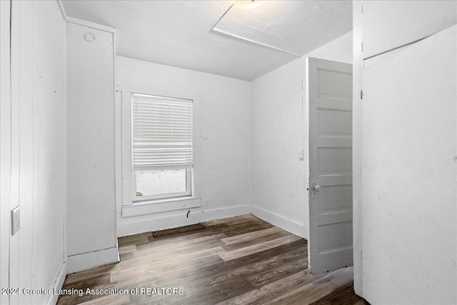 empty room with hardwood / wood-style flooring