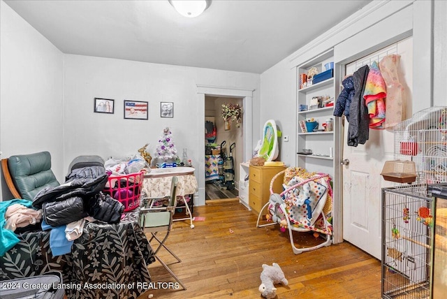 interior space with built in features and hardwood / wood-style flooring