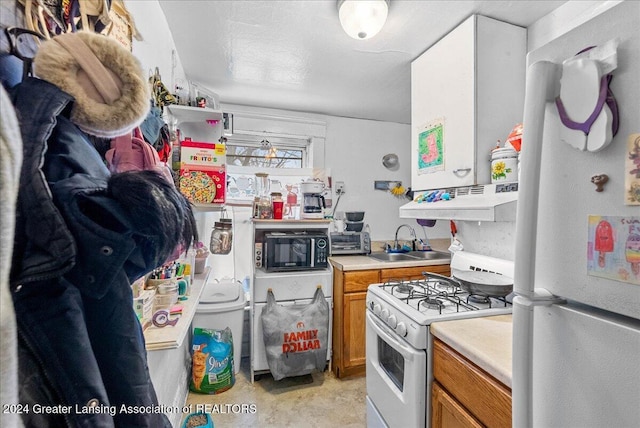 kitchen featuring sink and white appliances