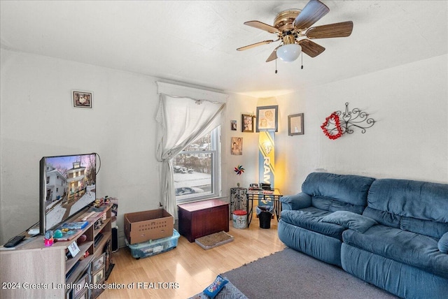 living room with hardwood / wood-style floors and ceiling fan