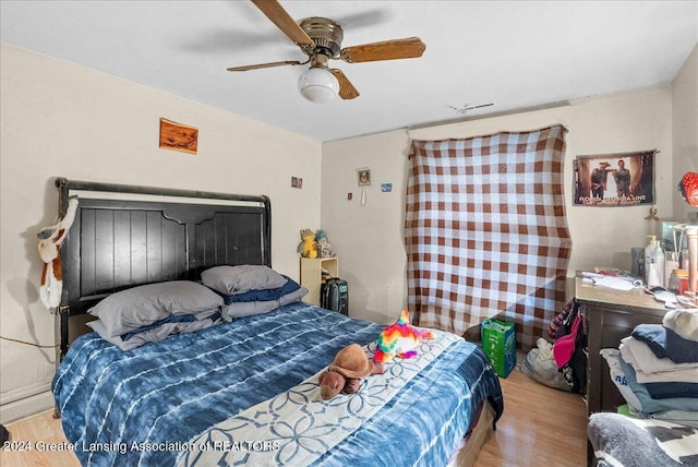 bedroom with ceiling fan and light wood-type flooring