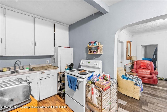 kitchen featuring sink, white appliances, white cabinets, and wood-type flooring