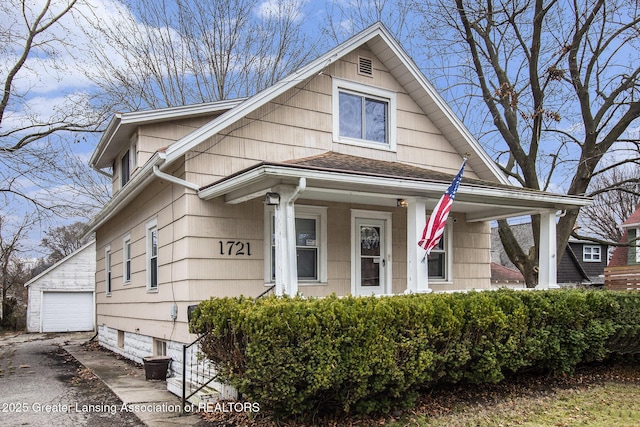 1721 Fletcher St, Lansing, MI 48910 - view of front of home featuring a porch, a garage, and an outbuilding