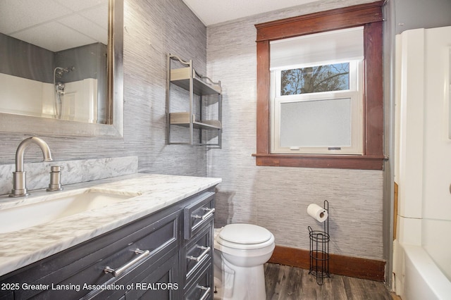 1721 Fletcher St, Lansing, MI 48910 - bathroom featuring toilet, vanity, wood finished floors, a shower, and a tub to relax in