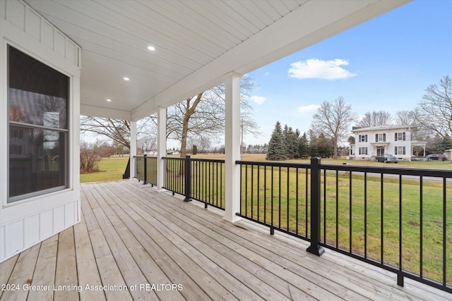 wooden terrace with a yard