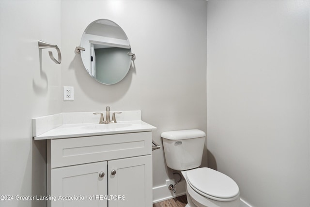 bathroom featuring hardwood / wood-style floors, vanity, and toilet