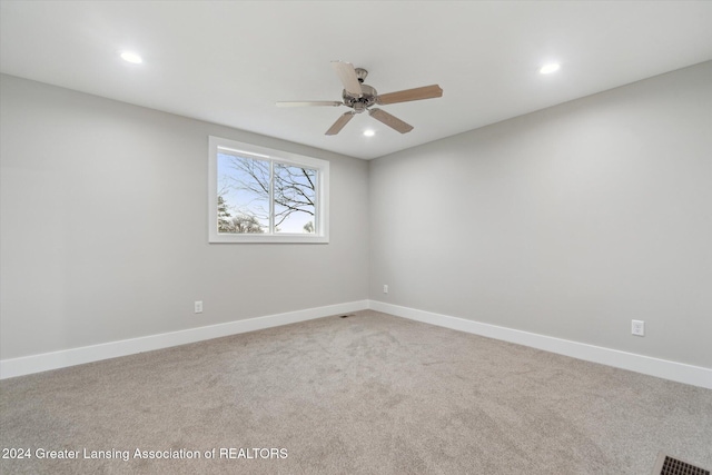 spare room with carpet flooring and ceiling fan