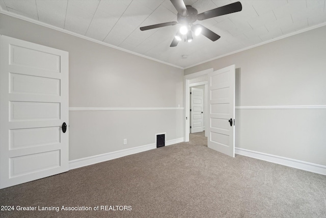 empty room with carpet, ceiling fan, and ornamental molding