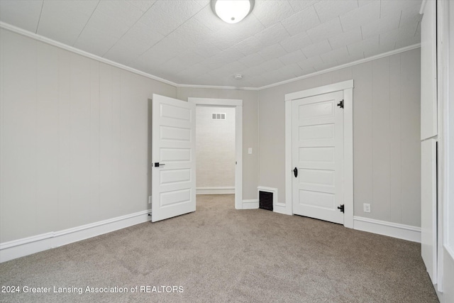 unfurnished bedroom featuring light carpet, a closet, and ornamental molding