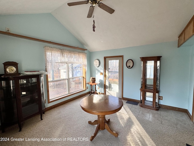 living area featuring ceiling fan, light carpet, and vaulted ceiling