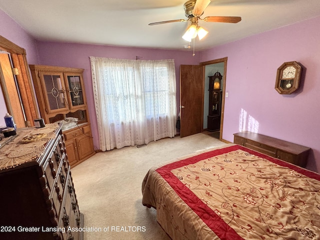 bedroom with ceiling fan and light colored carpet