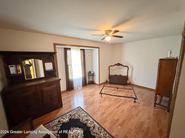 bedroom featuring ceiling fan, light wood-type flooring, and a closet