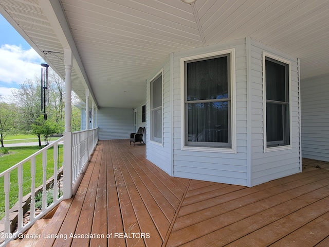 10004 Lakeside Dr, Perrinton, MI 48871 - deck featuring a porch and a yard
