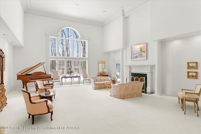 living room with a high end fireplace, light colored carpet, crown molding, and a high ceiling