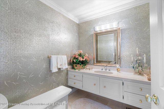 bathroom featuring tile patterned floors, crown molding, and vanity