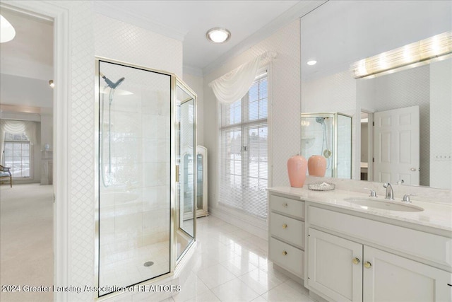 bathroom featuring tile patterned flooring, vanity, crown molding, and a shower with shower door